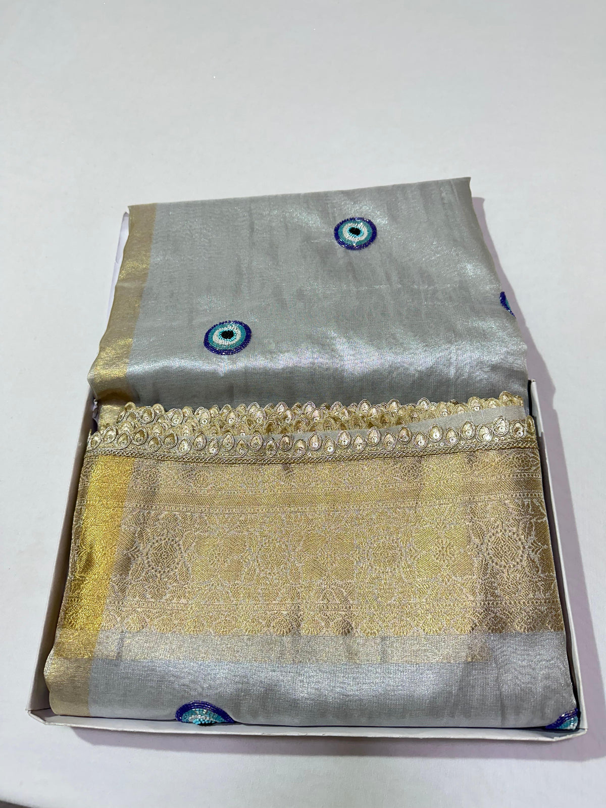 Silver Banarasi Semi Tissue Saree with Evil Eye Motifs &amp; Hand Ari Work