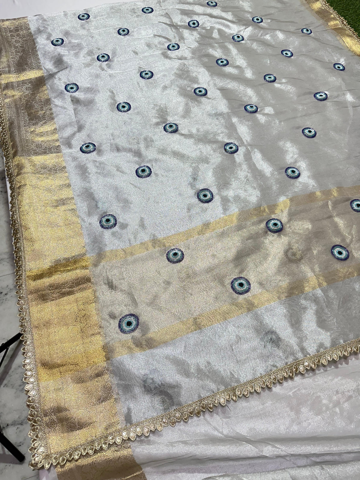 Silver Banarasi Semi Tissue Saree with Evil Eye Motifs &amp; Hand Ari Work